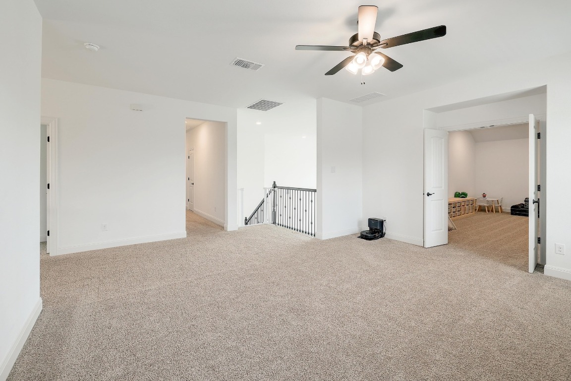 100 Garden Rose Pass Georgetown, TX 78628 - Photo 24 of 39 a view of a big room with chandelier fan and windows