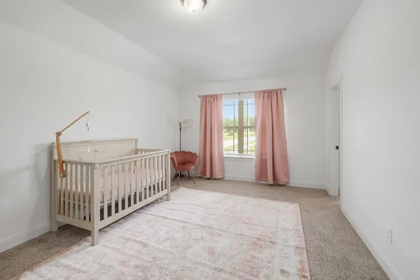 a view of a room with a bed and a window
