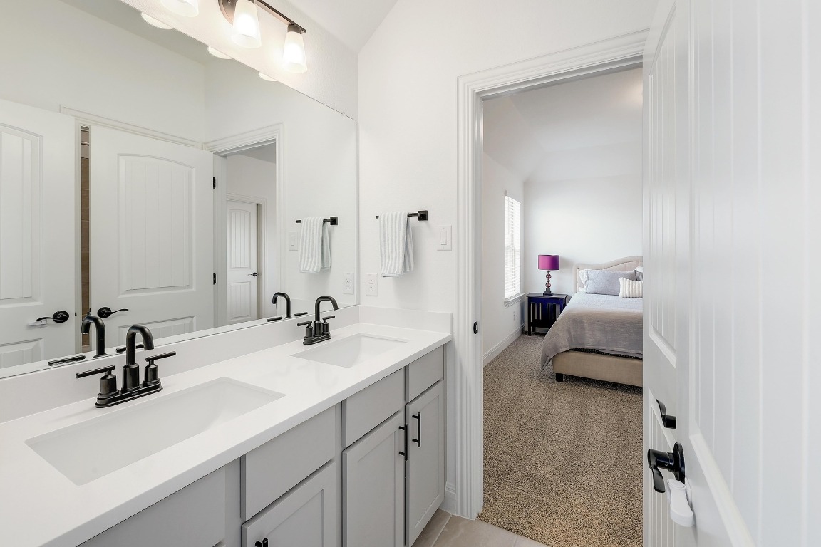 100 Garden Rose Pass Georgetown, TX 78628 - Photo 30 of 39 a en suite bathroom with double sink and a mirror