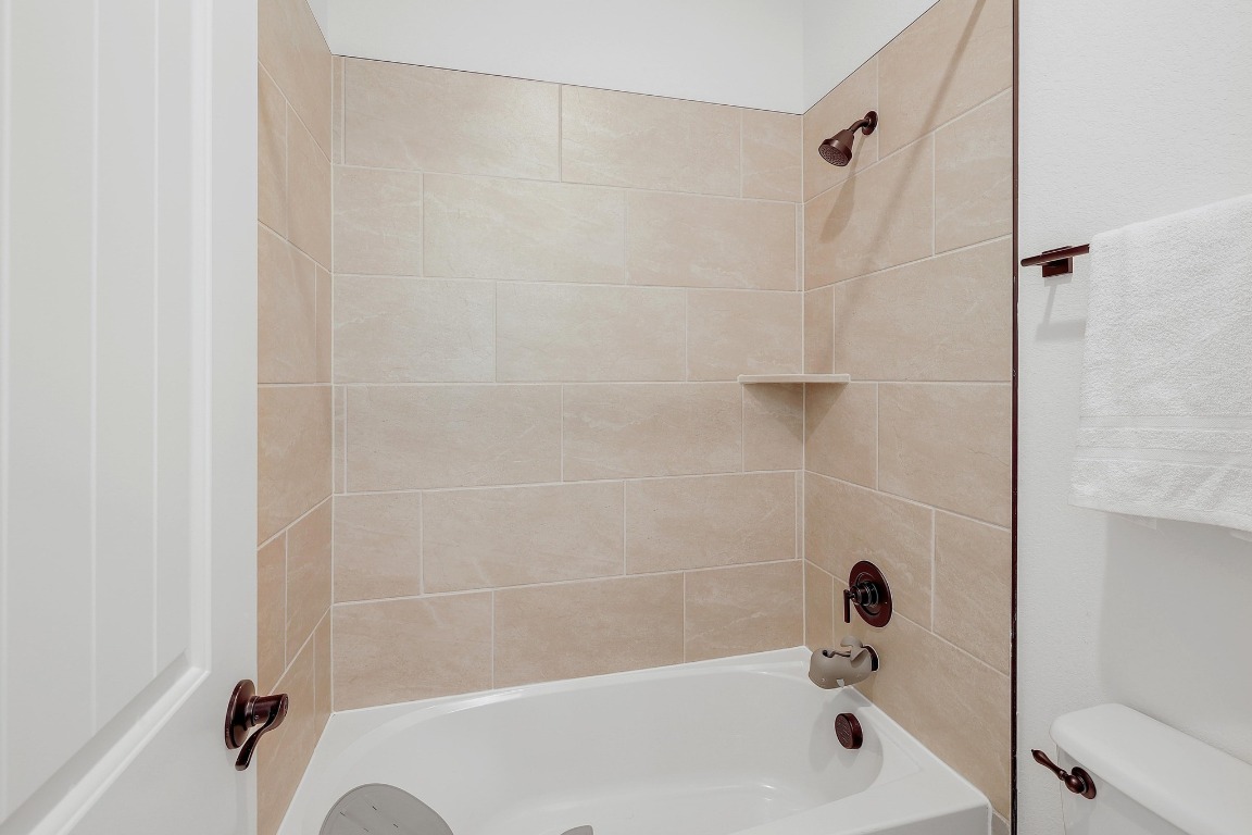 100 Garden Rose Pass Georgetown, TX 78628 - Photo 31 of 39 a bathroom with a bathtub and a shower
