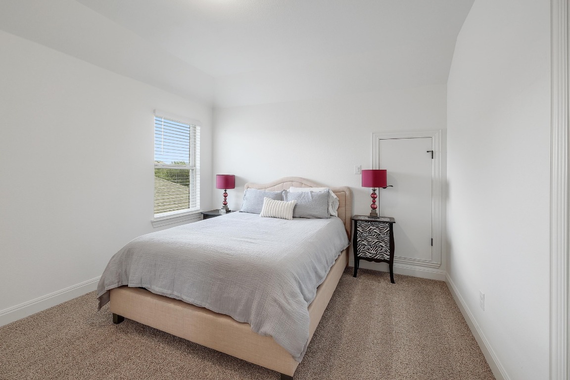 100 Garden Rose Pass Georgetown, TX 78628 - Photo 32 of 39 a bedroom with a bed and a closet