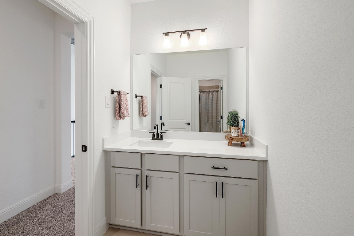 100 Garden Rose Pass Georgetown, TX 78628 - Photo 33 of 39 a bathroom with a sink and a mirror