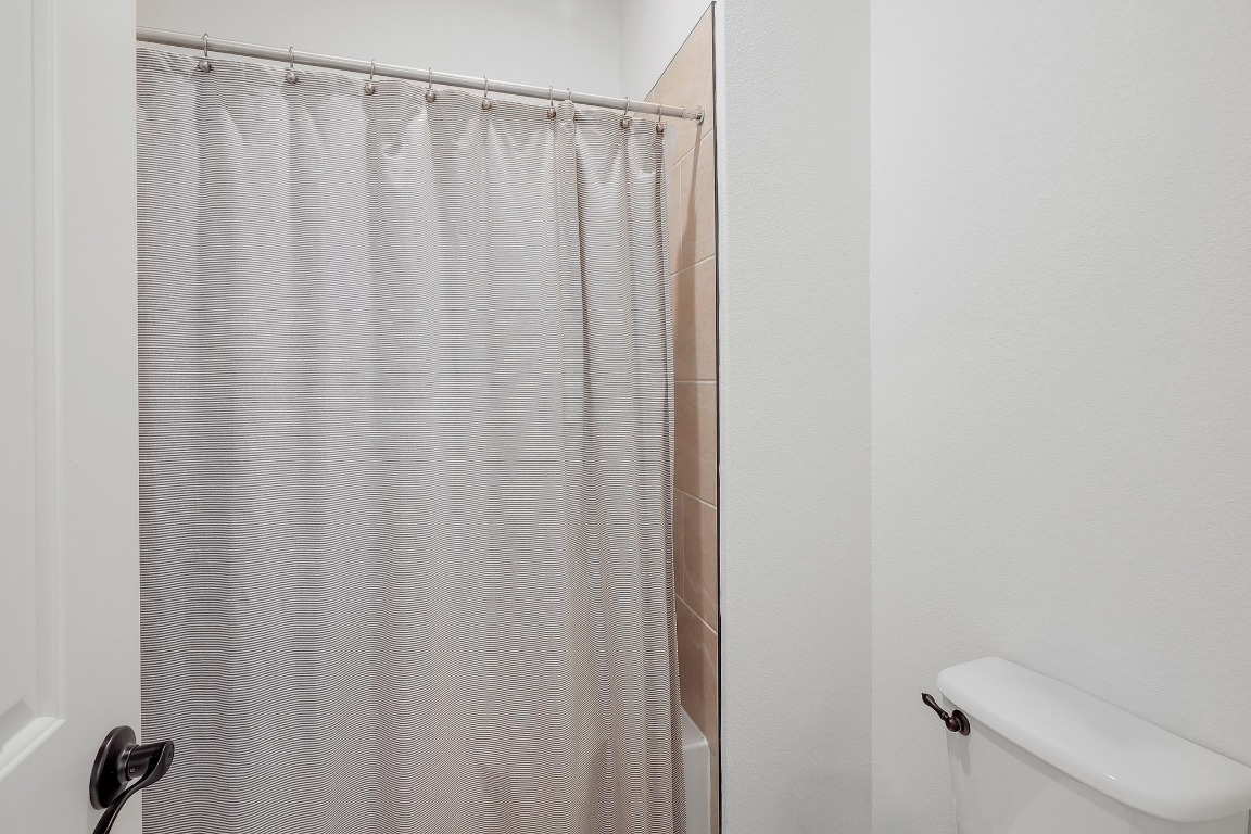 100 Garden Rose Pass Georgetown, TX 78628 - Photo 34 of 39 a bathroom with a shower curtain
