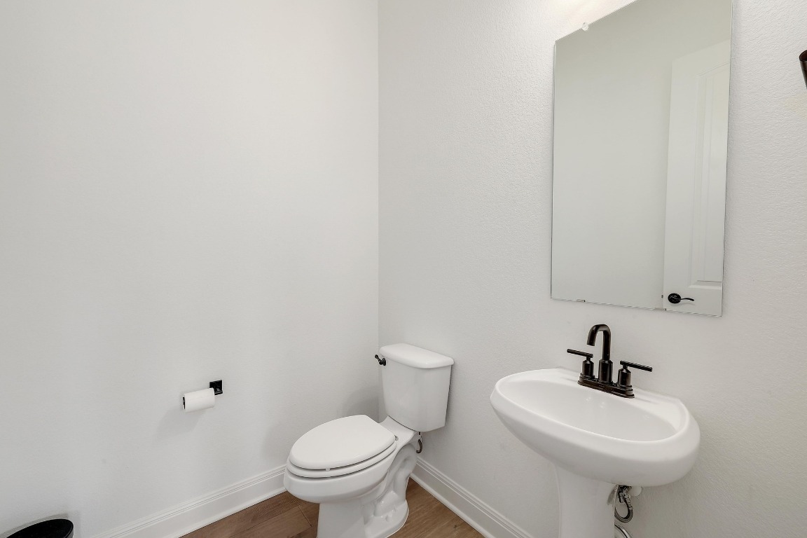 100 Garden Rose Pass Georgetown, TX 78628 - Photo 35 of 39 a bathroom with a sink a toilet and a mirror