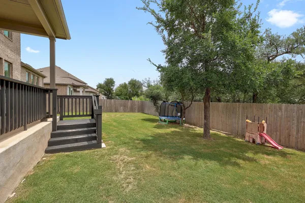 a view of a deck with a small yard