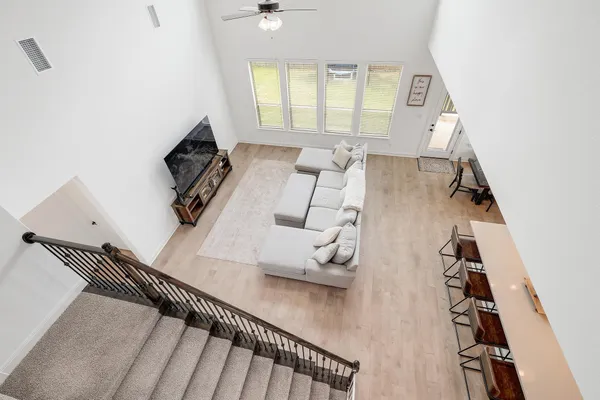 walk in closet with wooden floor and windows