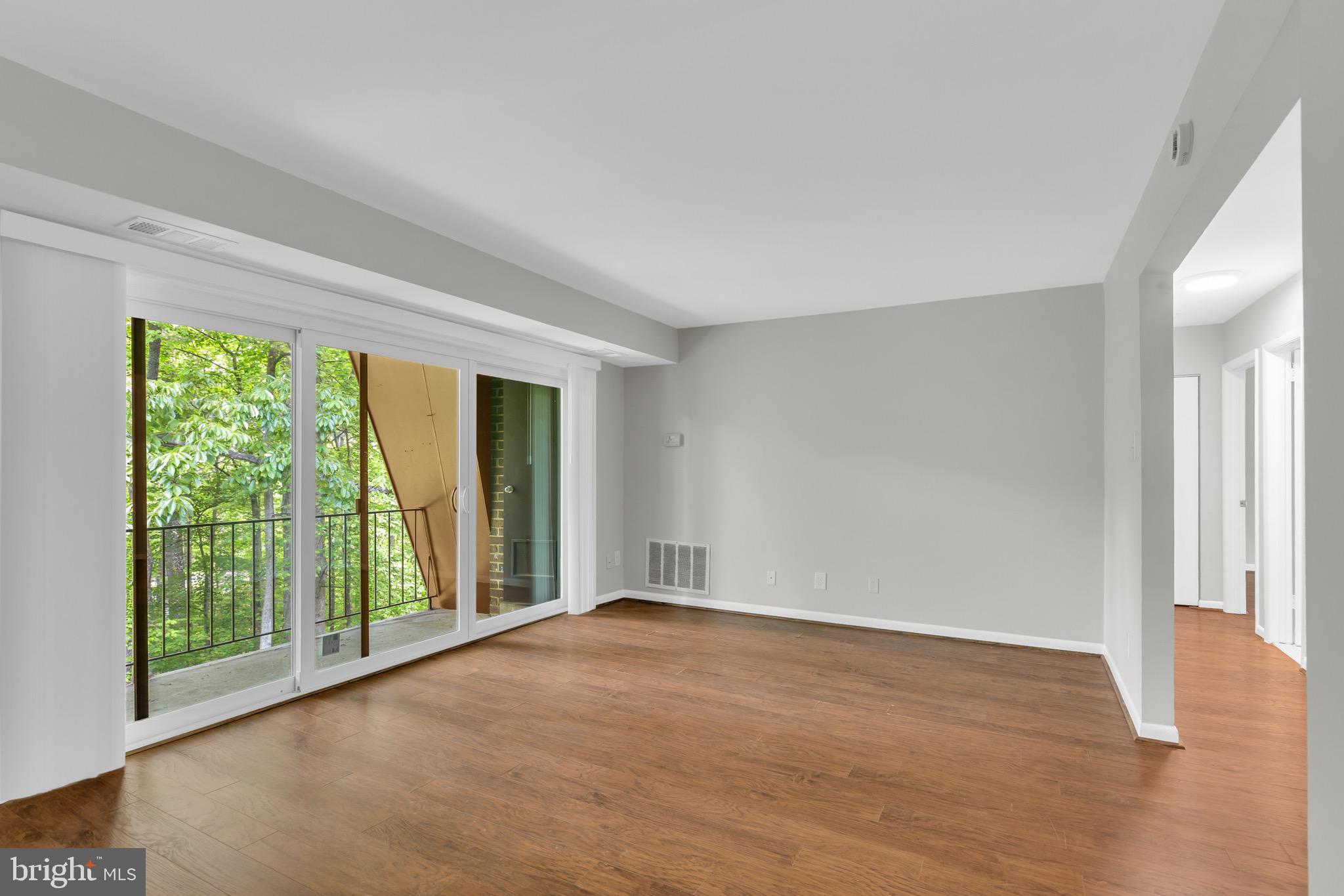11620 Vantage Hill Road, Unit 22B Reston, VA 20190 - Photo 10 of 24 a view of an empty room with wooden floor and a window