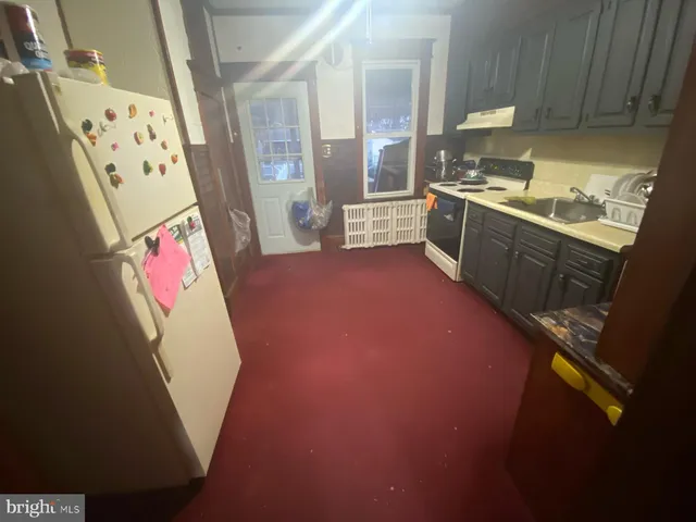 a view of kitchen with window and stainless steel appliances