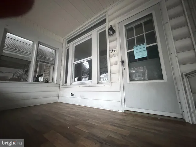 a view of white door and wooden floor