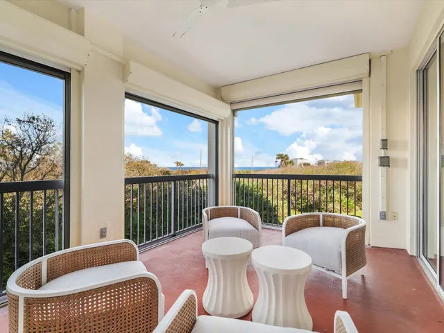 a dining room with wooden floor a glass table and chairs