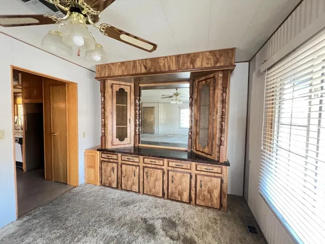 a view of a hallway with entryway and chandelier