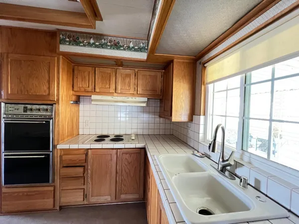 a kitchen with a sink cabinets and a window