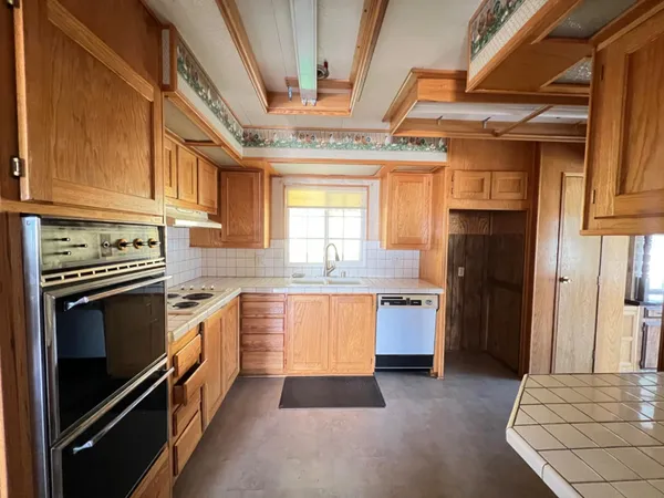 a kitchen with a refrigerator stove and sink