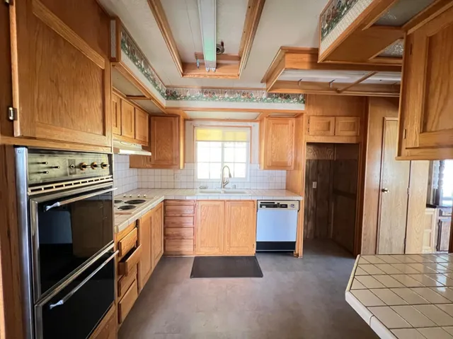 a kitchen with a refrigerator stove and sink