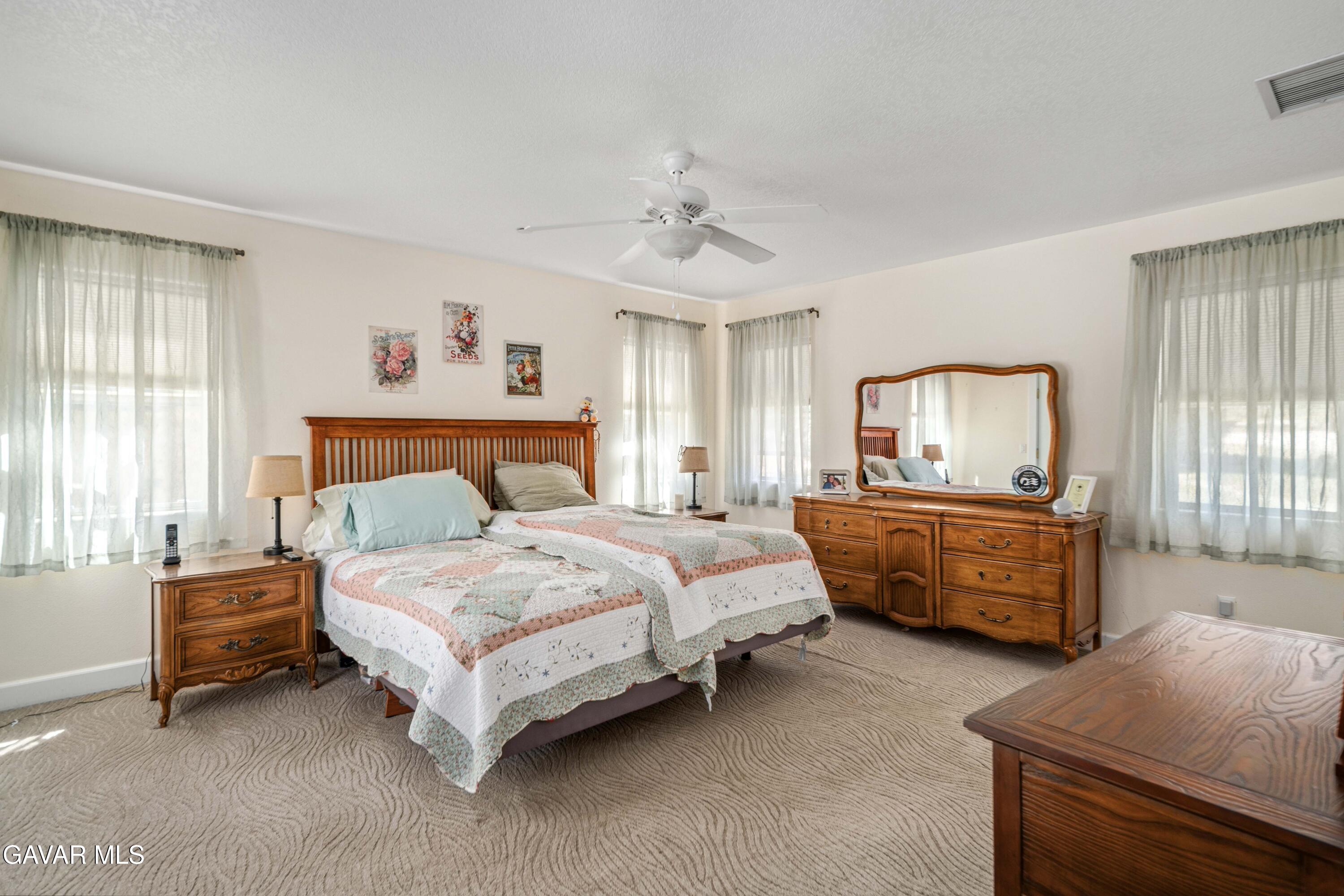 46472 Kings Canyon Road Lancaster, CA 93536 - Photo 16 of 33 a bedroom with a bed and a dresser