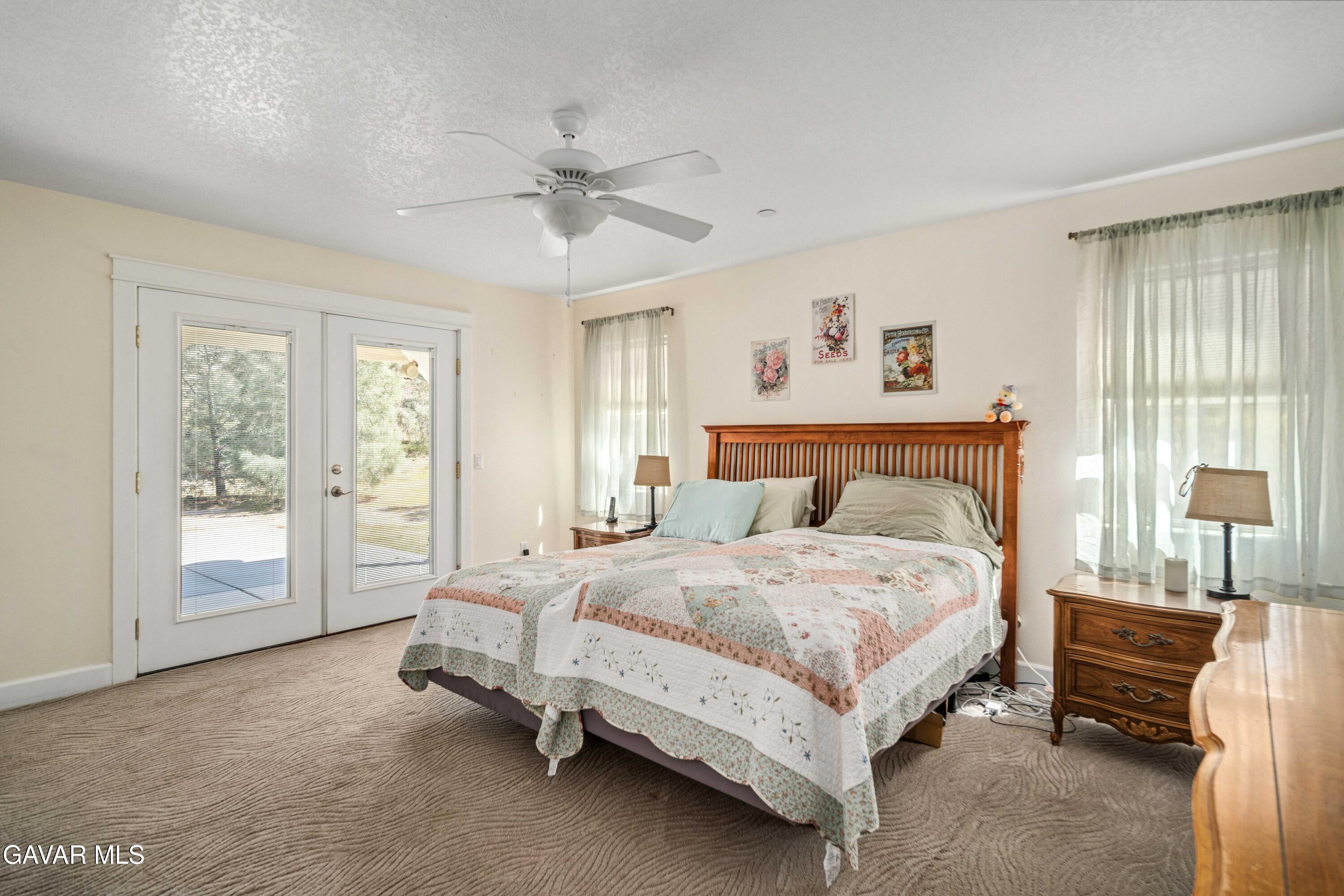 46472 Kings Canyon Road Lancaster, CA 93536 - Photo 17 of 33 a spacious bedroom with a bed and a large window