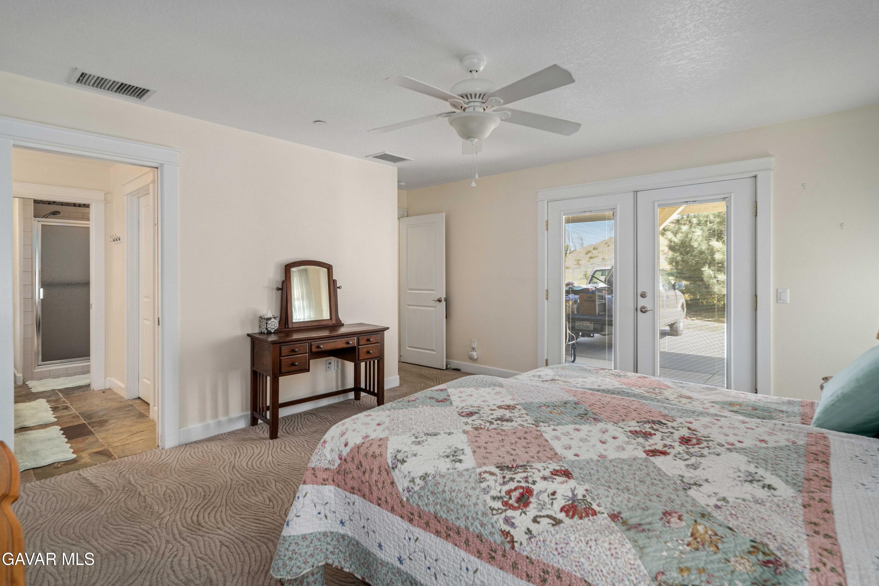 46472 Kings Canyon Road Lancaster, CA 93536 - Photo 18 of 33 a bedroom with a bed and a dresser with rug