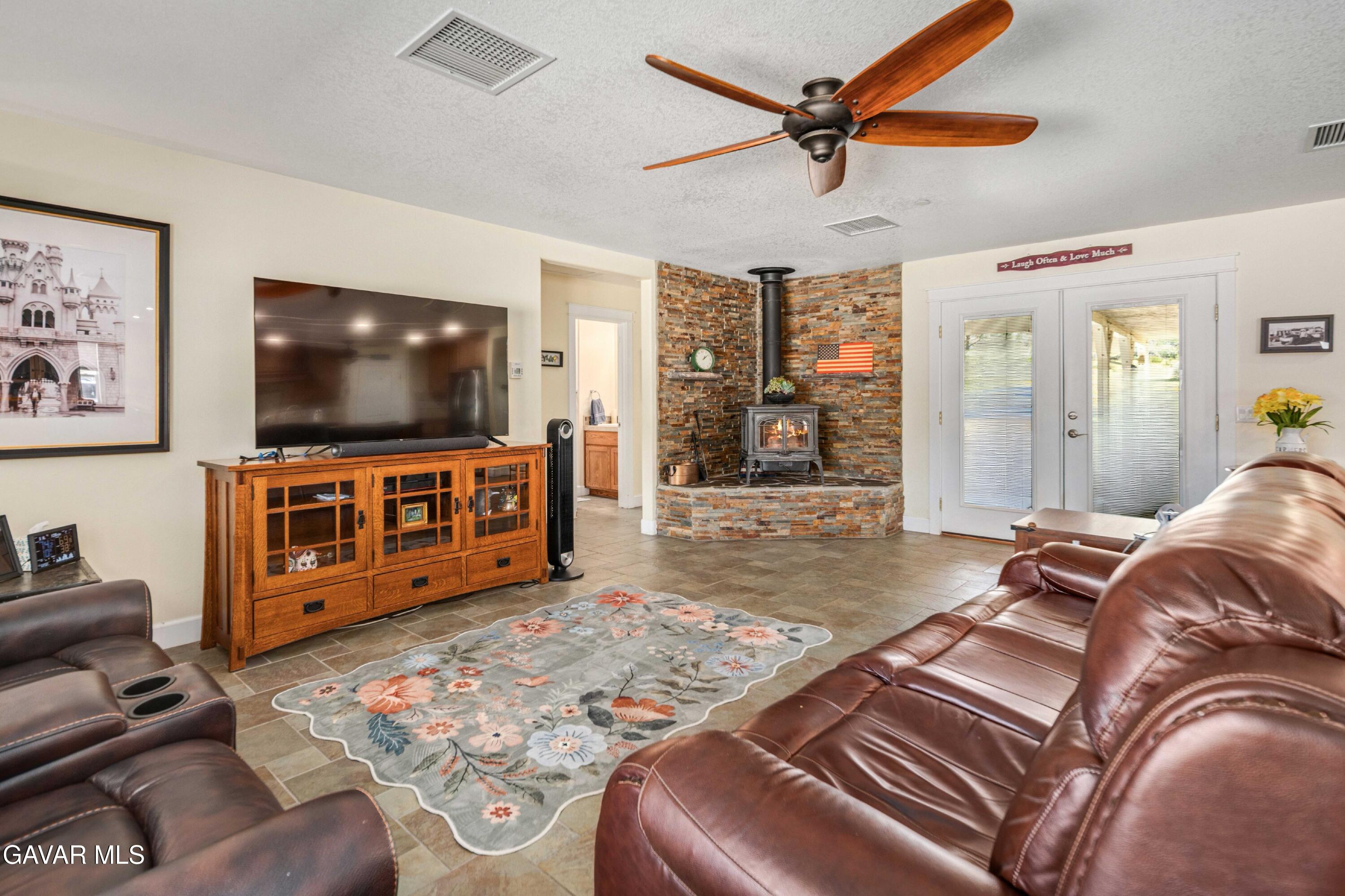 46472 Kings Canyon Road Lancaster, CA 93536 - Photo 6 of 33 a living room with furniture and a flat screen tv