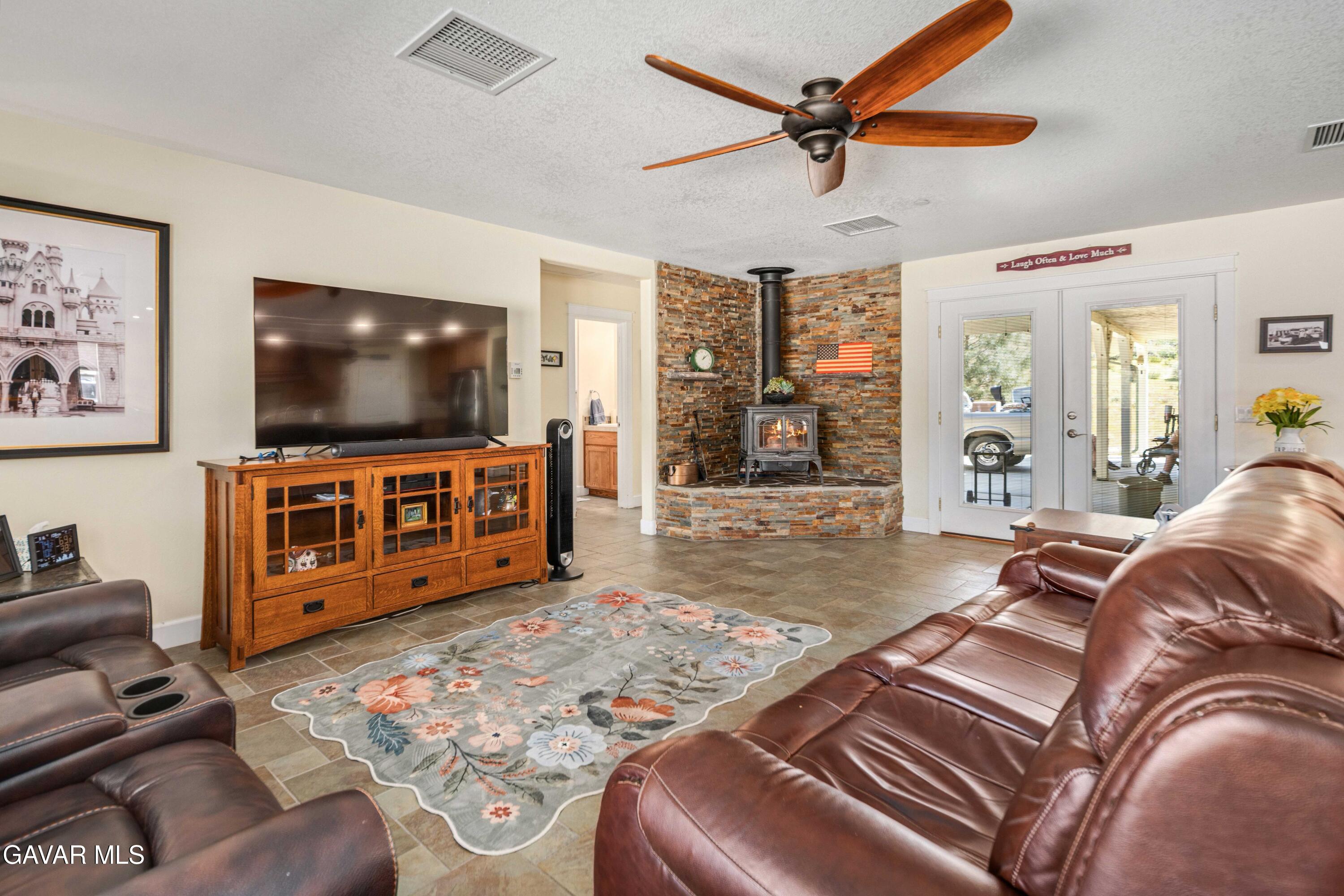 46472 Kings Canyon Road Lancaster, CA 93536 - Photo 7 of 33 a living room with furniture and a flat screen tv