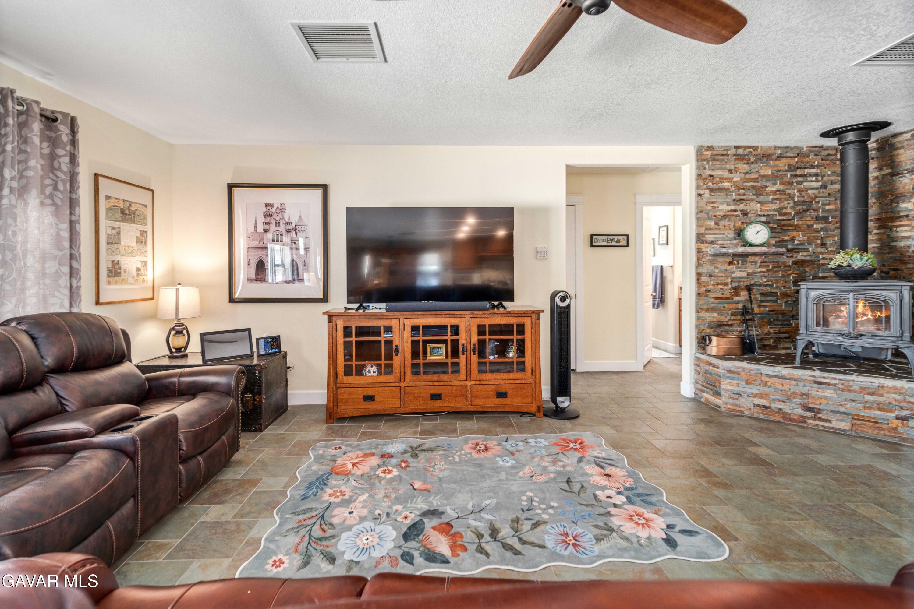 46472 Kings Canyon Road Lancaster, CA 93536 - Photo 8 of 33 a living room with furniture and a flat screen tv