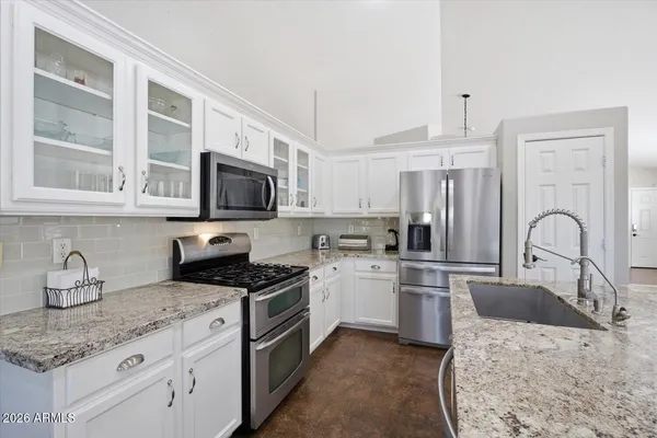 a kitchen with granite countertop cabinets and steel stainless steel appliances