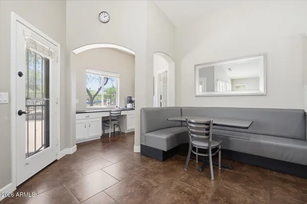 a kitchen with white cabinets and window