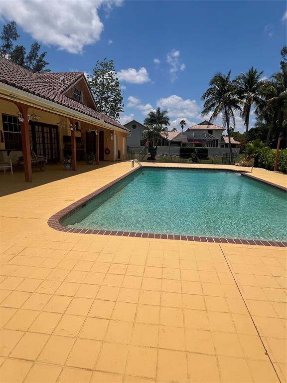11301 Southwest 3rd Street Plantation, FL 33325 - Photo 22 of 24 a view of a house with a swimming pool and a yard