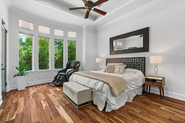 a dining room with furniture water view and a floor to ceiling window