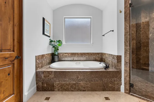 a bathroom with a granite countertop sink vanity and mirror