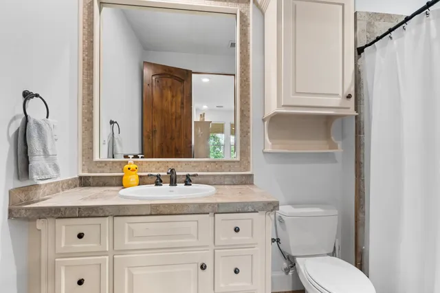 a bed sitting in a spacious bedroom next to a window