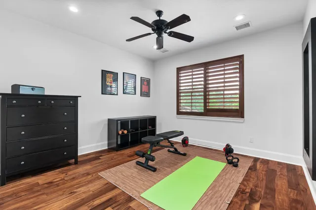 a bathroom with a granite countertop toilet sink and mirror