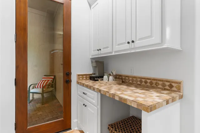 a view of a hallway with windows and bathroom