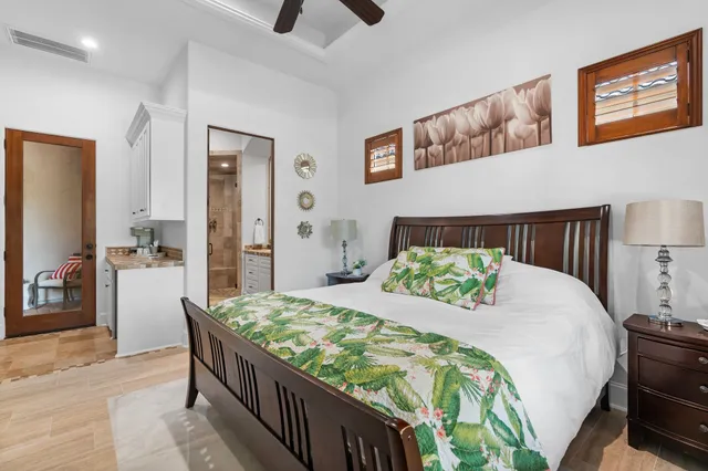 a bathroom with a granite countertop sink a mirror a glass door and shower