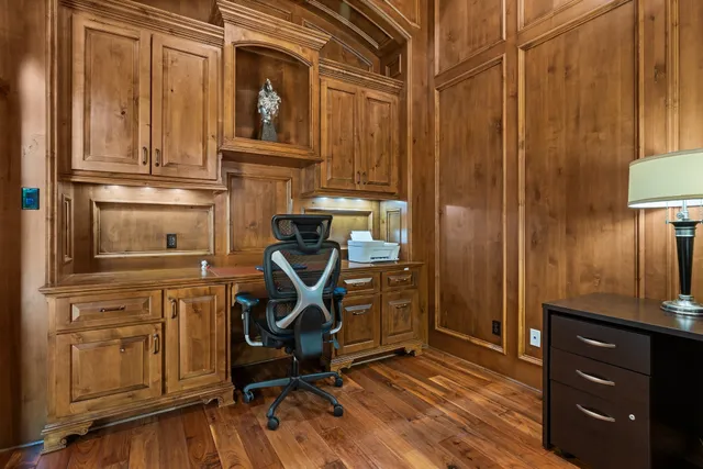 a view of a dining room with furniture a chandelier and wooden floor
