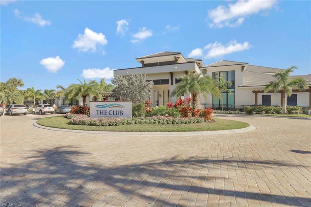 295 Grande Way, Unit 1202 Naples, FL 34110 - Photo 34 of 36 a front view of a building with retail shops