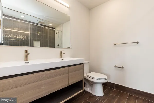 a bathroom with a sink toilet and mirror
