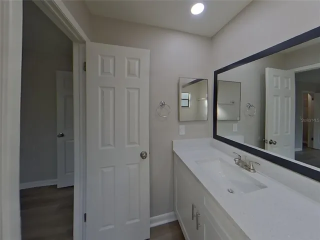 a bathroom with a sink and a mirror