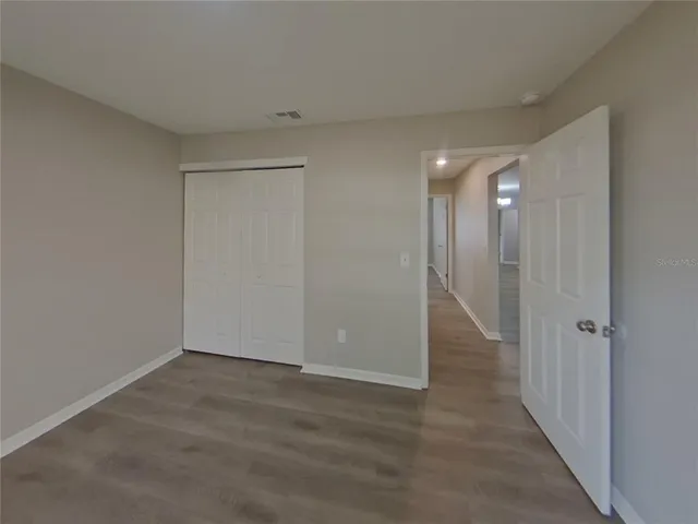 a view of hallway with wooden floor
