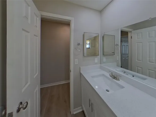 a bathroom with a sink and mirror