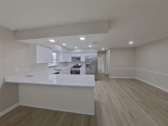a view of kitchen with wooden floor