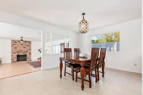 a view of a dining room with furniture and chandelier