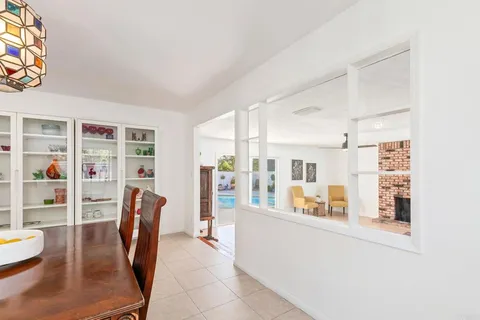 a living room with furniture a fireplace and a floor to ceiling window