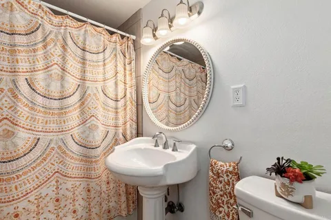 a bedroom with a bed and a large window