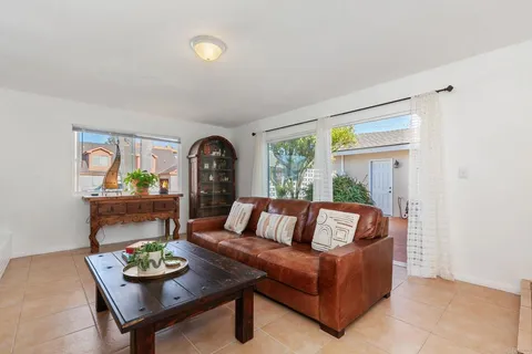 a view of a living room filled with furniture and a large window
