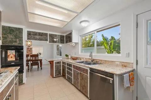 a kitchen with a sink stove and refrigerator