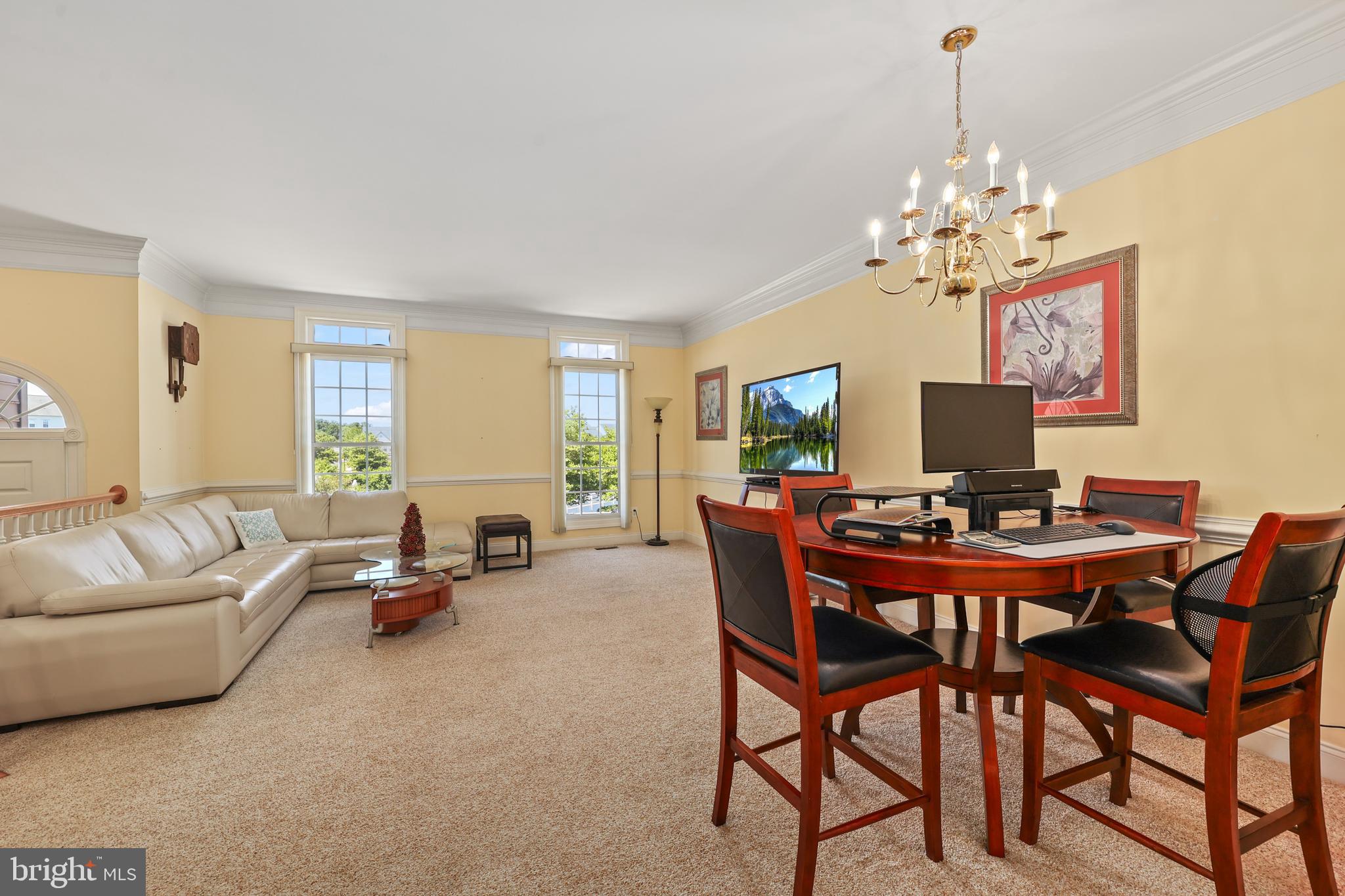 6806 Witton Circle Gainesville, VA 20155 - Photo 4 of 47 a view of a dining room with furniture and a chandelier