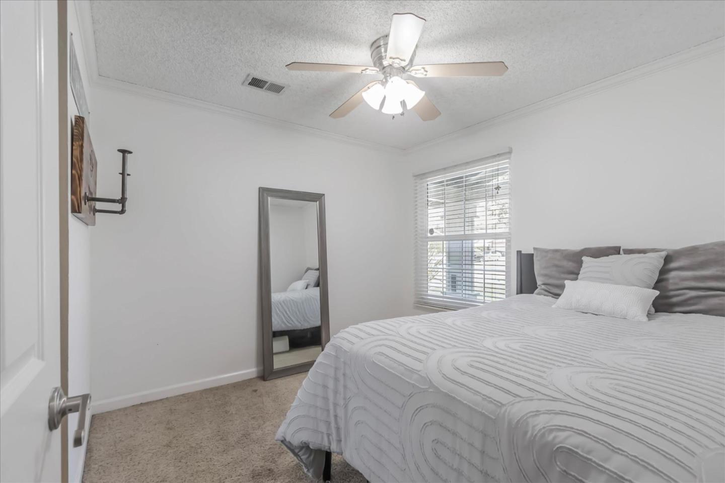 5075 Eppling Lane San Jose, CA 95111 - Photo 21 of 60 a bedroom with a large bed and a chandelier