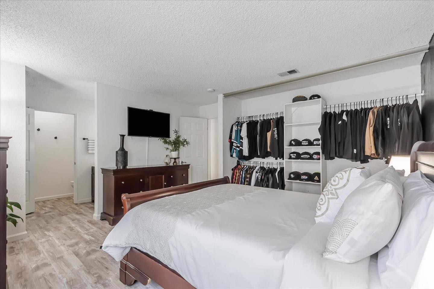 5075 Eppling Lane San Jose, CA 95111 - Photo 26 of 60 a large bedroom with a bed and a flat screen tv