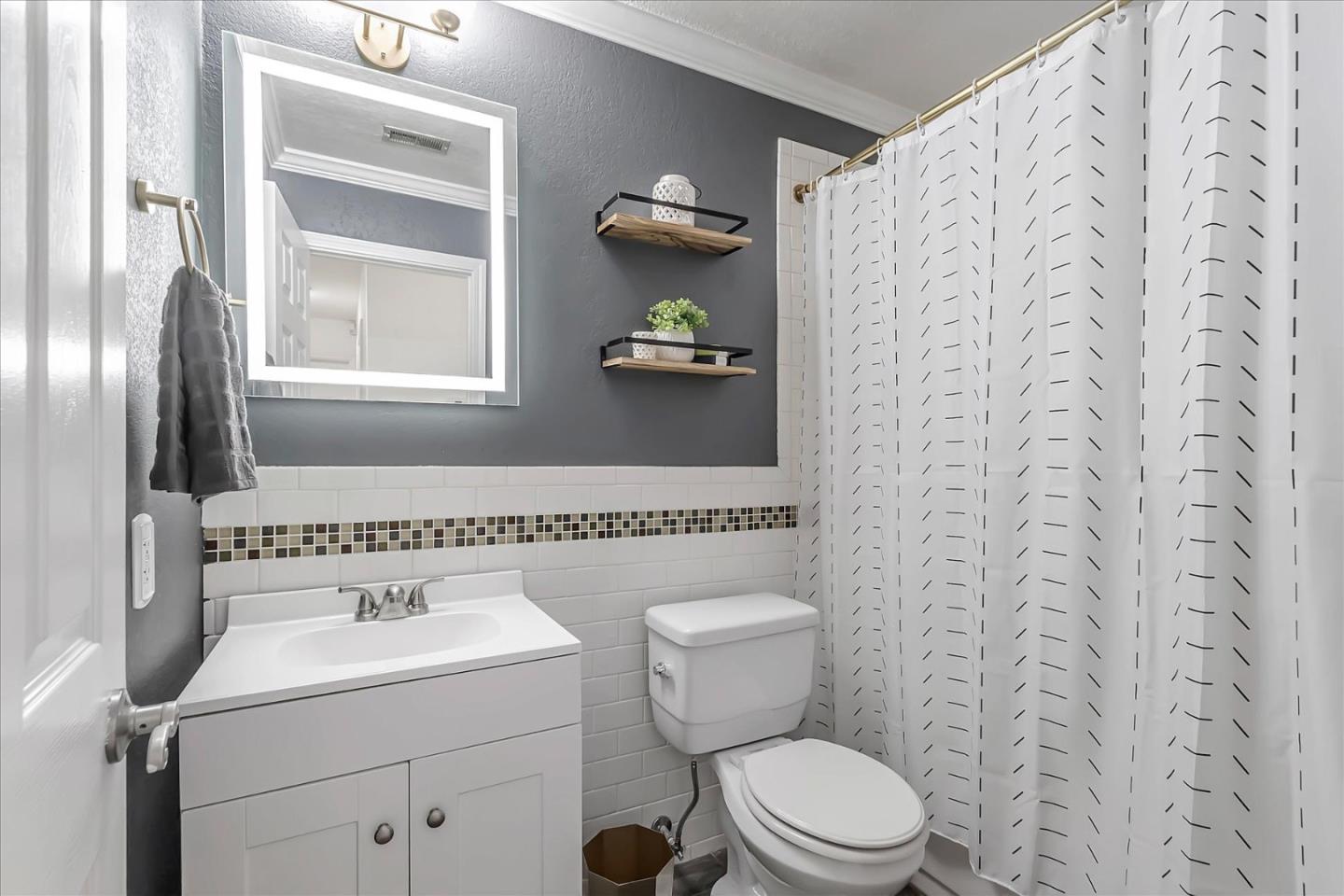 5075 Eppling Lane San Jose, CA 95111 - Photo 30 of 60 a bathroom with a toilet sink and mirror