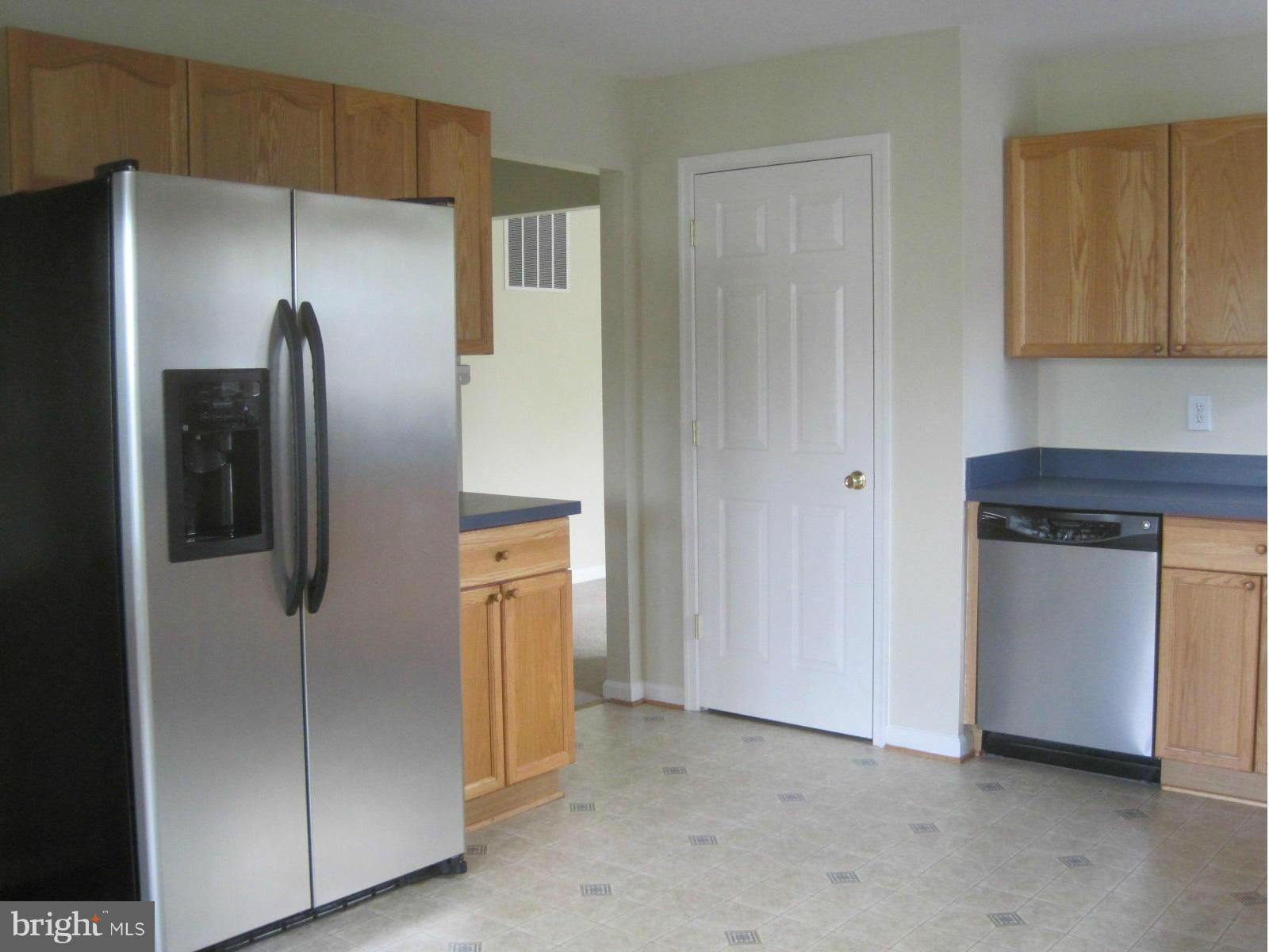 Kitchen features stainless appliances and pantry